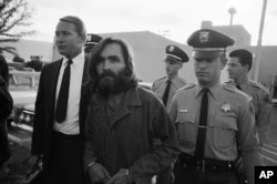 Charles Manson leaves a Los Angeles courtroom, Dec. 22, 1969 after telling a judge "lies have been told" about him.