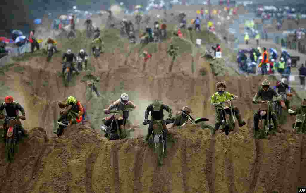 Riders reach the crest of a dune during the opening lap of the main race of the 2013 RHL Weston beach race in Weston-Super-Mare, southwest England, Oct. 13, 2013. 