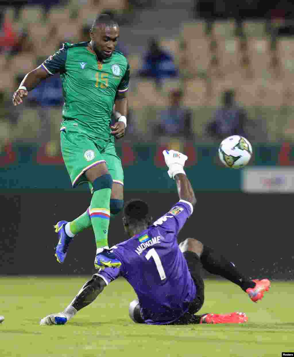 Comoros&#39; Bendjaloud Youssouf in action with Gabon&#39;s Jean-Noel Amonome.