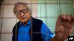 FILE - Win Tin, a former political prisoner and an opposition party stalwart poses for a picture at his home in Rangoon, Burma.