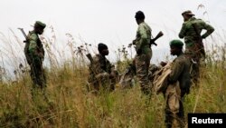 FILE - Soldiers from the Democratic Republic of Congo take positions near its border with Rwanda after fighting broke out in eastern Congo, June 12, 2014. 