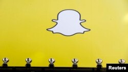 FILE - A billboard displays the logo of Snapchat above Times Square in New York, March 12, 2015.