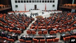 Lawmakers are seen during a debate at Turkey's parliament in Ankara, Oct. 4, 2012. Turkey fired on Syrian targets for a second day Thursday, but said it has no intention of declaring war, despite tensions after deadly shelling from Syria killed five civil