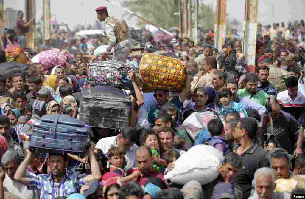 Displaced Sunnis, who fled the violence in the city of Ramadi, arrive at the outskirts of Baghdad, Iraq. Iraqi security forces fought Islamic State militants at the gates of the western city on Friday, and local authorities warned it was in danger of falling unless reinforcements arrived soon.