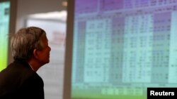 A investor looks at stock market screens at a securities company in Hanoi, Vietnam, April 20, 2016. 