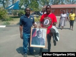 Mourners holding a portrait of the late former president Robert Mugabe in Zvimba communal lands, Mashonaland West.