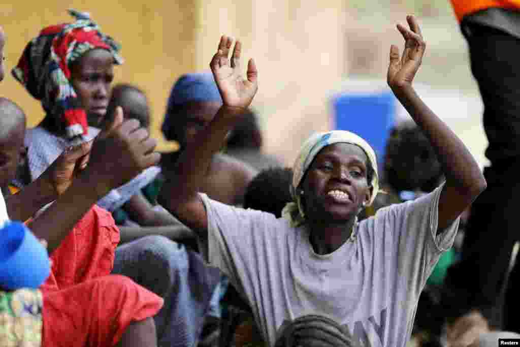 A woman rescued from Boko Haram in Sambisa forest celebrates her freedom at Malkohi camp for Internally Displaced People in Yola, Adamawa State, Nigeria May 3, 2015. Hundreds of traumatised Nigerian women and children rescued from Boko Haram Islamists hav