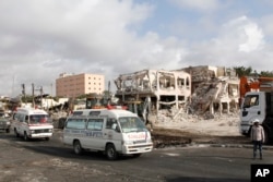FILE - Ambulances carrying wounded victims pass the scene of Saturday's truck bomb blast, as they head to the airport for victims to be airlifted for treatment in Turkey, in Mogadishu, Somalia, Oct. 16 2017.