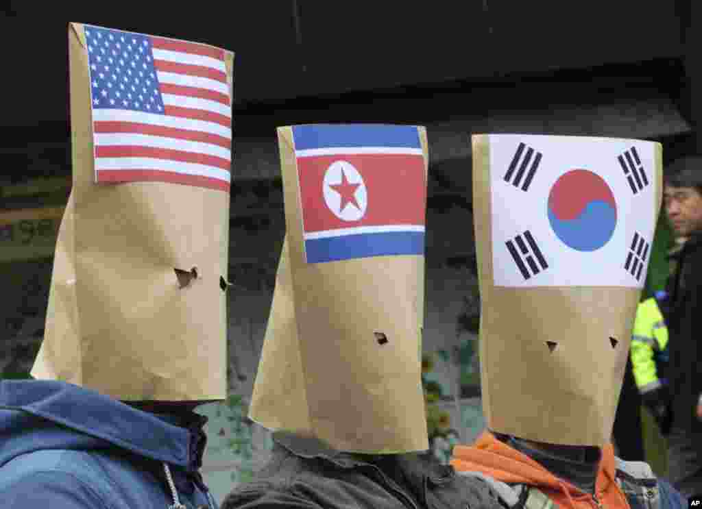 South Korean protesters wearing envelopes participate in a rally to mark Global Day of Action on Military Spending near the U.S. embassy in Seoul.