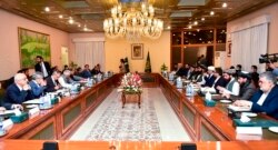 Pakistan's Foreign Minister Shah Mahmood Qureshi, fifth left, holds talks with Afghan delegation led by Amir Khan Muttaqi, sixth right, in Islamabad, Pakistan, Nov. 11, 2021. (Pakistan Ministry of Foreign Affairs via AP)