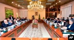 Pakistan's Foreign Minister Shah Mahmood Qureshi, fifth left, holds talks with Afghan delegation led by Amir Khan Muttaqi, sixth right, in Islamabad, Pakistan, Nov. 11, 2021. (Pakistan Ministry of Foreign Affairs via AP)