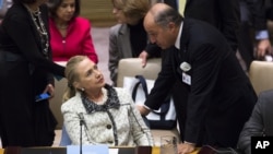 United States Secretary of State Hillary Clinton speaks to French Foreign Minister Laurent Fabius before a meeting of the Security Council during the 67th United Nations General Assembly, at U.N. headquarters in New York, September 26, 2012. 