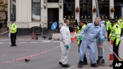 Forensic police investigate in the London Bridge area of London, June 5, 2017. 