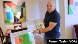 In his acrylic-filled home in Houston, artist Ammar Alobaidi flashes a May 2017 copy of Houstonia magazine, which features his work and life story.