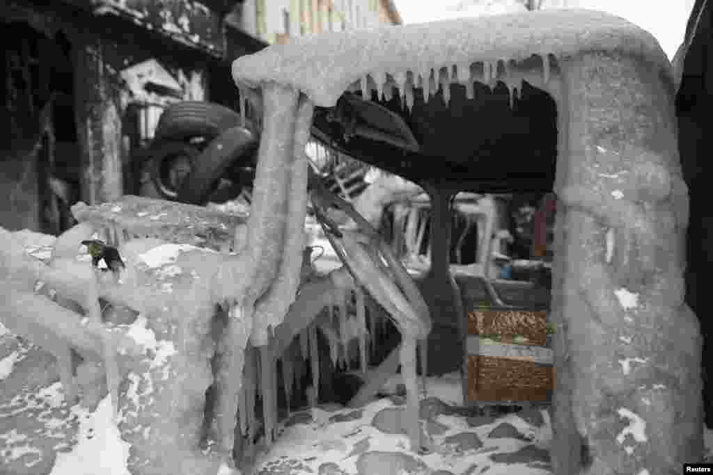 The cabin of a gutted truck is covered with ice at fortifications erected by anti-government protesters in Kyiv, Jan. 29, 2014.&nbsp;