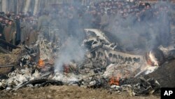 Kashmiri villagers gather near the wreckage of an Indian aircraft after it crashed in Budgam area, outskirts of Srinagar, Indian-controlled Kashmir, Feb. 27, 2019. 