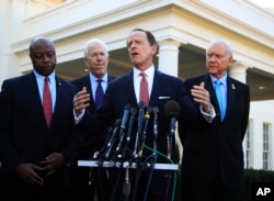 Senate Finance Committee member Sen. Patrick Toomey, R-Pa., second from right, with, from left, Sens. Tim Scott, R-S.C., John Cornyn, R-Texas,, and Chairman Orrin Hatch, R-Utah, speaks to reporters following a meeting with President Donald Trump at the White House.