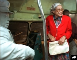FILE - Rosa Parks visits an exhibit illustrating her bus ride of December, 1955 at the National Civil Rights Museum in Memphis, Tennessee, July 15, 1995.