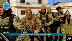 Fighters from al-Qaida's branch in Syria, the Nusra Front, marching toward the northern village of al-Ais in Aleppo province, Syria. (File)