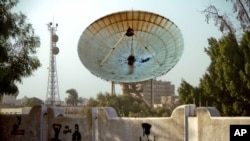 A satellite dish stands damaged after an attack on Egypt's main satellite station in the Maadi district of Cairo October 7, 2013.