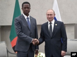 President Edgar Chagwa Lungu of Zambia, left, and Russia's President Vladimir Putin pose for a photo at the BRICS summit in Johannesburg, South Africa, July 26, 2018.