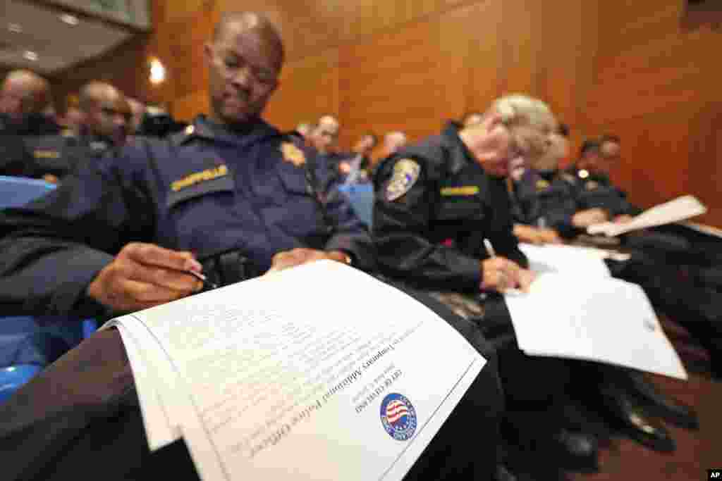 Over 300 officers from other jurisdictions fill out paperwork after being sworn in to have police powers in Cleveland, as preparations are made for the Republican National Convention, in Cleveland, July 16, 2016.
