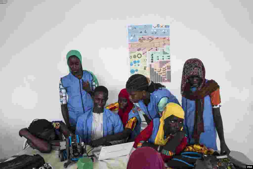 Students from CEM Serigne Bassirou Mbacke school in Kaolack, Senegal, test at their robot at the 2017 Pan-African Robotics Competition in Dakar, Senegal, May 19, 2017. (R. Shryock/VOA)