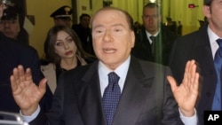 Former Italian Premier Silvio Berlusconi speaks to reporters after a hearing in his Mediaset appeals trial, at Milan's court, Italy, Mar. 1, 2013.