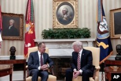 President Donald Trump, right, meets Russian Foreign Minister Sergey Lavrov at the White House in Washington, May 10, 2017. (Russian Foreign Ministry photo via AP)