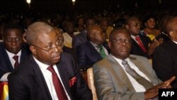 Democratic Republic of Congo PM Adolphe Muzito (L) and former minister Godefroid Mayobo attend the extraordinary session of the National Assembly in Kinshasa, February 16, 2012. 