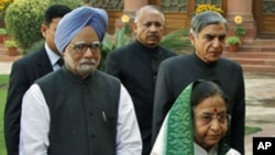 India's Prime Minister Manmohan Singh and President Pratibha Patil arrive at the parliament on the first day of the budget session in New Delhi, February 21, 2011