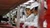 FILE - Workers at a Foxconn factory in Longhua, Guangdong province, China, May 26, 2010. Foxconn is Apple's main supplier of iPhones.