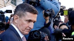 Former U.S. national security adviser Michael Flynn passes by members of the media as he departs after his sentencing was delayed at U.S. District Court in Washington, U.S., Dec. 18, 2018.