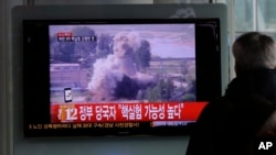 A South Korean man watches a TV news showing a file footage of North Korea's nuclear test at the Seoul train station in Seoul, South Korea, February 12, 2013. 