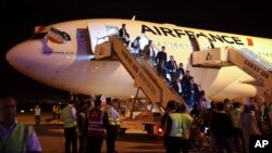 FILE - Passengers exit an Air France plane after it landed at Tehran's Imam Khomeini International Airport, south of the capital Tehran, Iran.