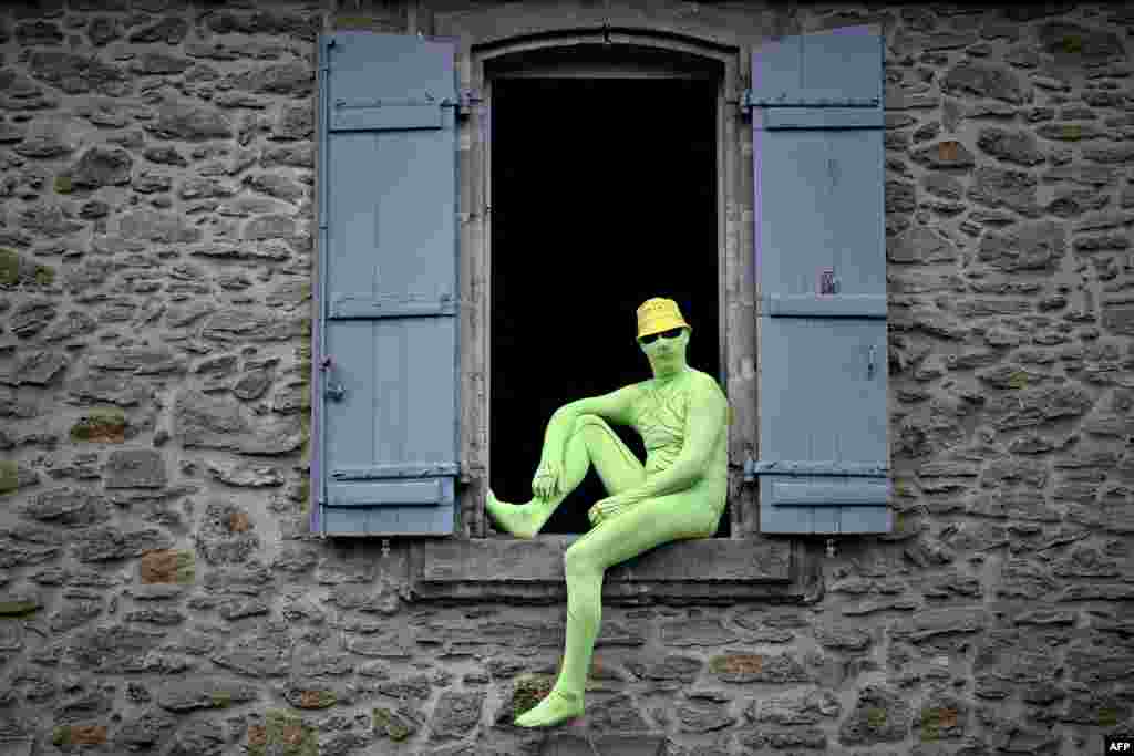 A fan watches the 19th stage of the 108th edition of the Tour de France cycling race.