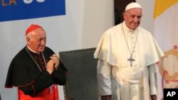 FILE - Pope Francis is pictured with Cardinal Ricardo Ezzati Andrello at the Pontifical Catholic University of Chile in Santiago, Jan.17, 2018. Ezzati told reporters on July 12, 2018, following Oscar Munoz's arrest on sex abuse charges, that he felt "great pain, for him, for his family and for the victims."