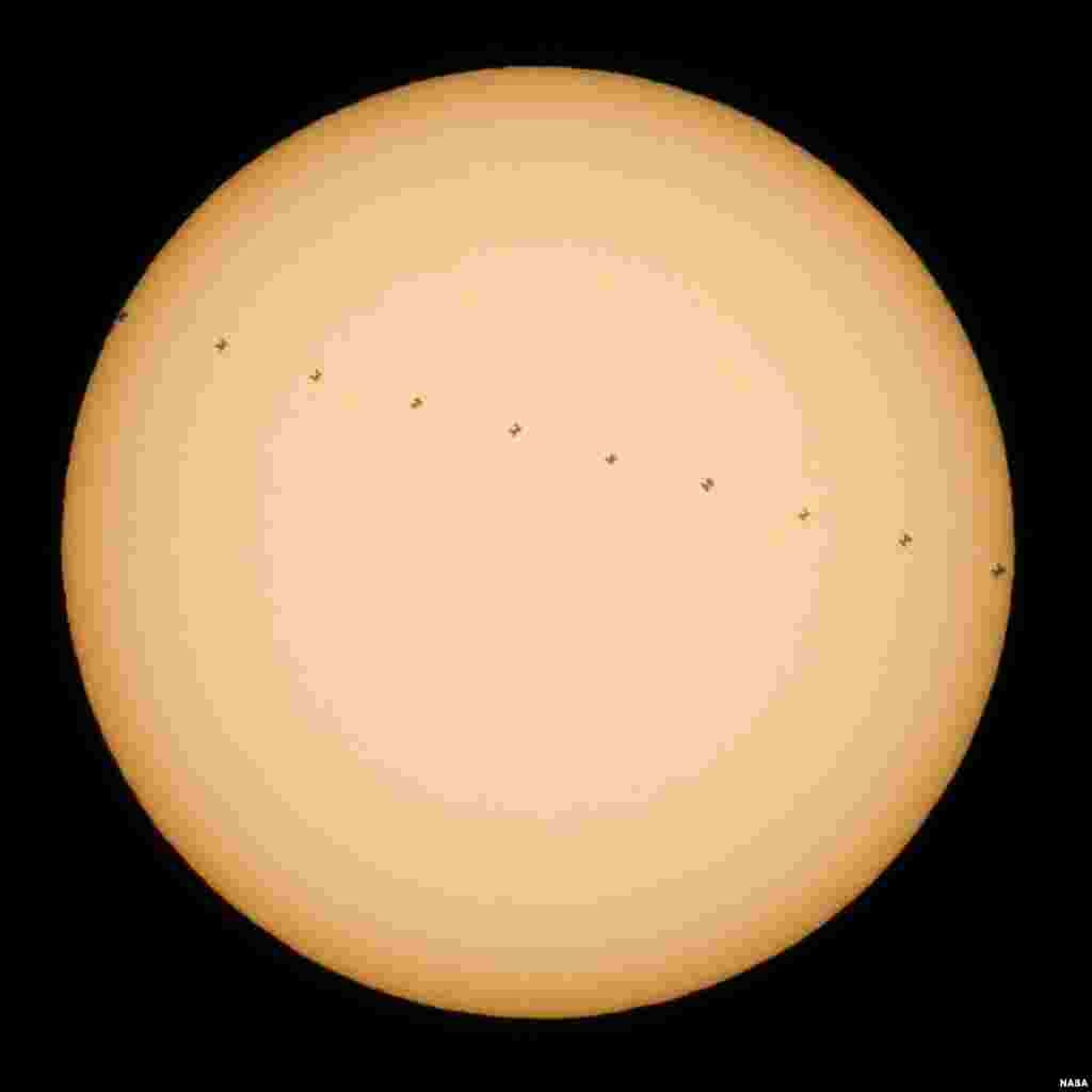 This composite image, made from ten frames, shows the International Space Station, with a crew of six onboard, in silhouette as it transits the sun at roughly five miles per second, from Newbury Park, California, Dec. 17, 2016.