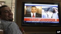 A Jordanian man reacts as he watch a TV news report about the killing of Osama bin Laden at a coffeshop in Amman, Jordan, Monday, May 2, 2011.