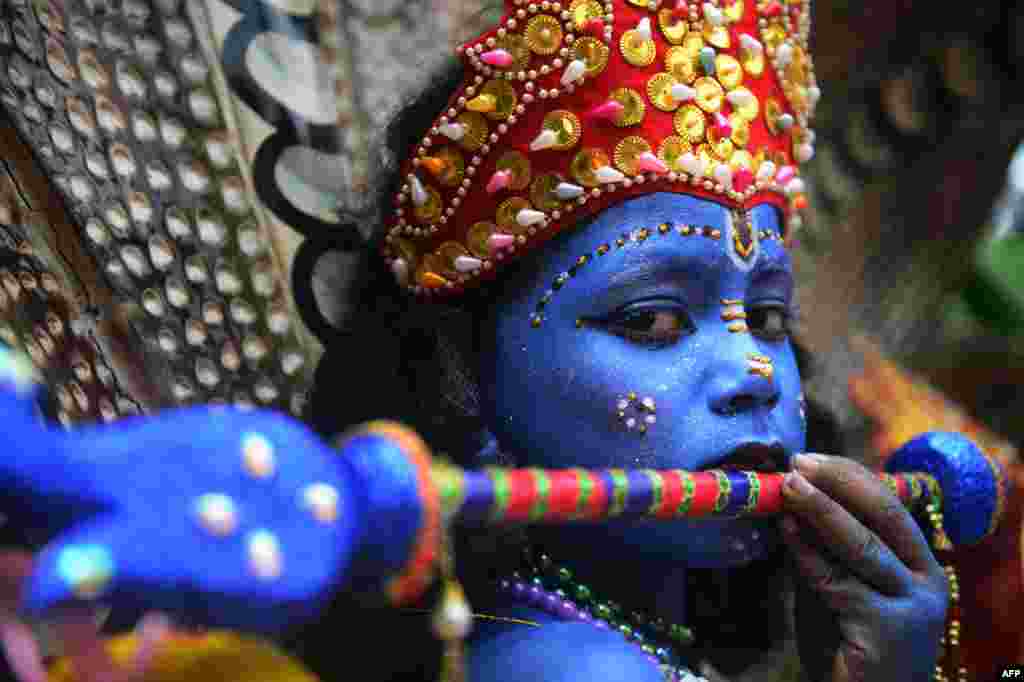 A Bangladeshi youth dressed as the Hindu god Lord Krishna takes part in a celebrations for the Janmashtami festival in Dhaka.