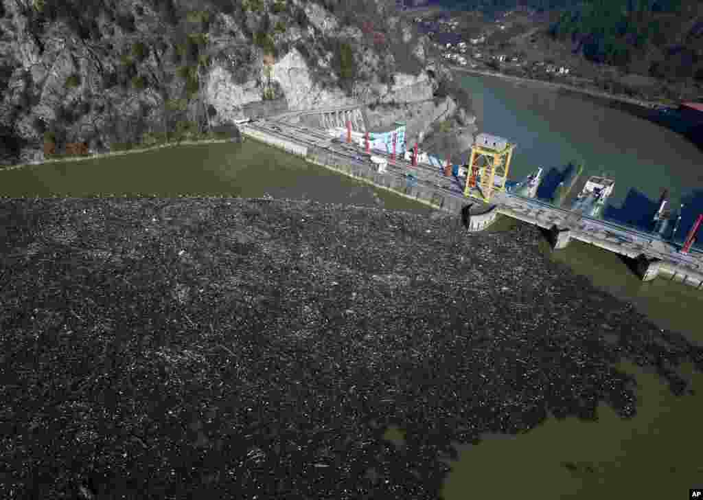 This is aerial photo shows plastic bottles, wooden planks, rusty barrels and other garbage clogging the Drina river near the eastern Bosnian town of Visegrad, Bosnia.