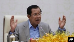 FILE: Cambodia's Prime Minister Hun Sen gestures during a speech on the current state of a new virus from China in Phnom Penh, Cambodia, Thursday, Jan. 30, 2020. Cambodia's leader has urged citizens to remain calm about the new virus from China, which has been confirmed in a sing