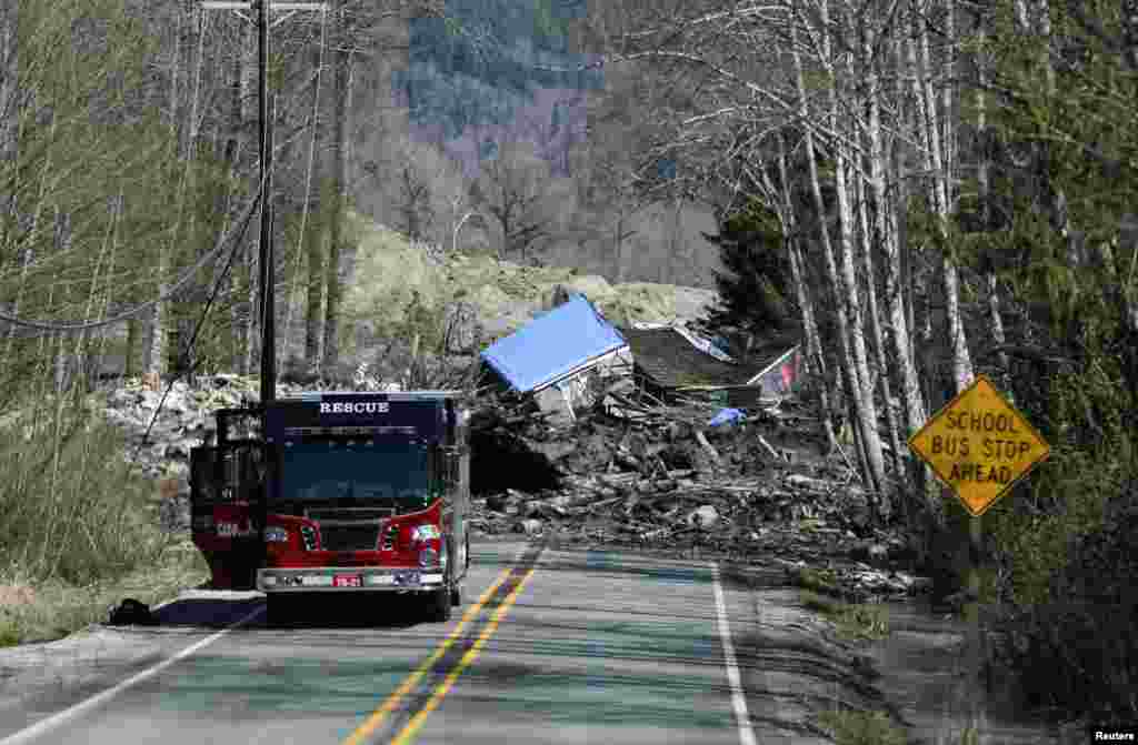 A emergency vehicle is parked as a landslide and debris block Highway 530 near Oso, Washington, March 23, 2014. 