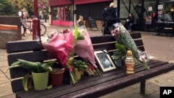 Flowers and candles are seen at a memorial to Arkadiusz Jozwik in Harlow, England, Oct. 20, 2016. Jozwik, an immigrant from Poland who was known as Arek, died following an altercation with local youths. Police are investigating his death as a hate crime.