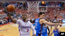 FILE: The Los Angeles Clippers' Chris Paul, left, puts up a shot against Oklahoma City Thunder center Steven Adams during Game 6 of the Western Conference semifinal NBA playoffs in Los Angeles, Calif., on May 15, 2014.