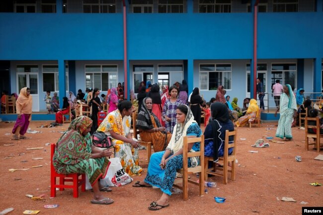 People relocated to a school building because of an overnight gunbattle between troops and suspected Islamist militants on the east coast of Sri Lanka are seen in Kalmunai, April 27, 2019.