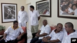 FILE - These Cuban doctors, waiting for the start of a press conference in Havana, were among 91 health workers who traveled to Liberia and Guinea to help with treatment of Ebola patients, Oct. 21, 2014.