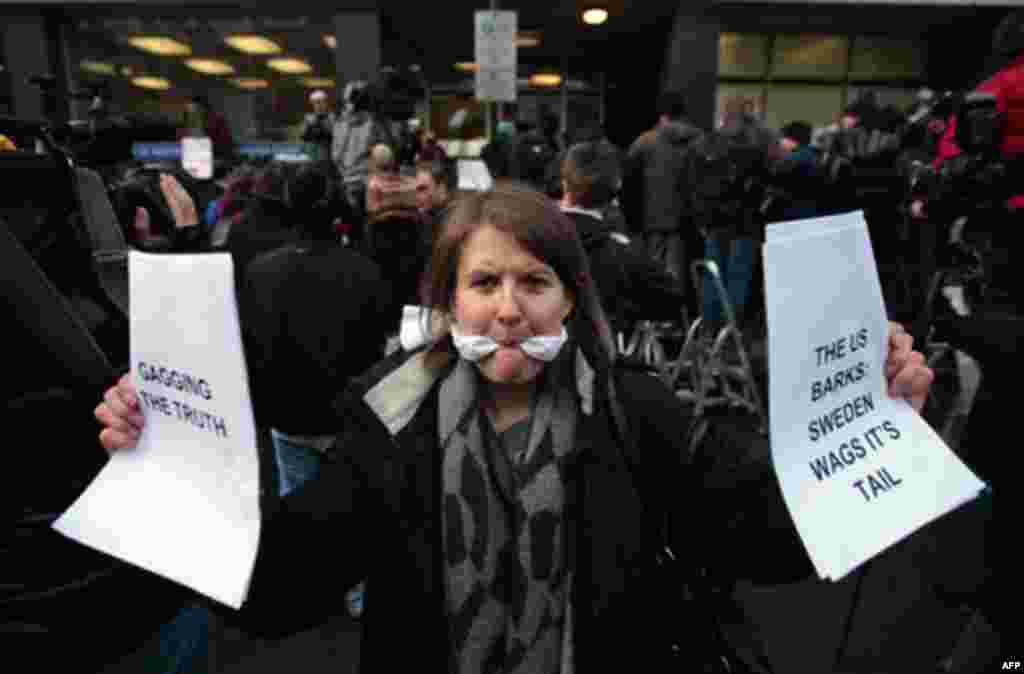 A supporter of Wikileaks founder Julian Assange, poses for members of the media outside the City of Westminster Magistrates Court in London where Julian Assange's case was heard, Tuesday, Dec. 7, 2010. Julian Assange was jailed Tuesday after the WikiLeak