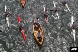 Paris Mayor Anne Hidalgo (C, bottom) sails with the co-president of the Paris bid for the 2024 Olympics Tony Estanguet (C, up) on the Seine river in Paris, June 23, 2017, in a bid to promote the candidacy of the city of Paris for the Summer Olympics Games.