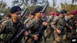 FILE - El Salvador army special forces march during a presentation to the press as part of a stepped-up phase in the government's fight against gangs in San Salvador, El Salvador, April, 20, 2016. The government of El Salvador deployed 1,000 soldiers and police to fight gangs in rural areas. 